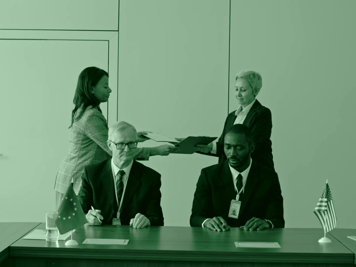 Documents being handed across an office table